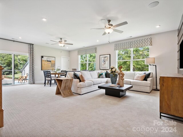 carpeted living room featuring ceiling fan