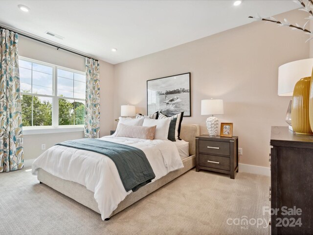 bedroom featuring light colored carpet