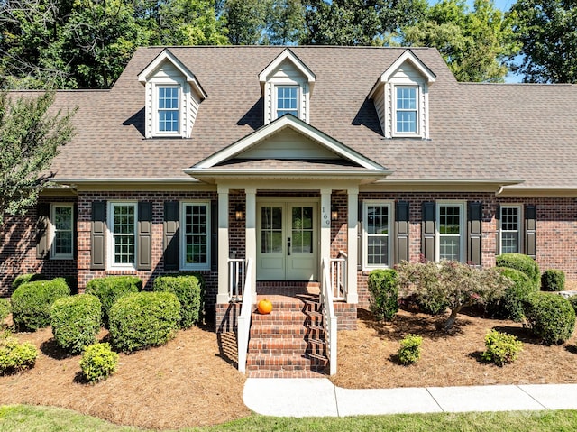 cape cod-style house featuring a porch