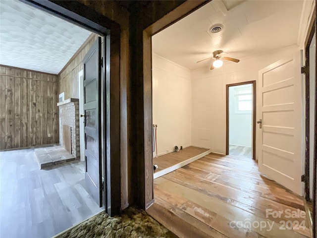 corridor featuring wooden walls and hardwood / wood-style floors