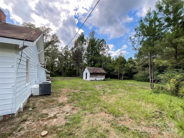 view of yard with a storage shed and central AC