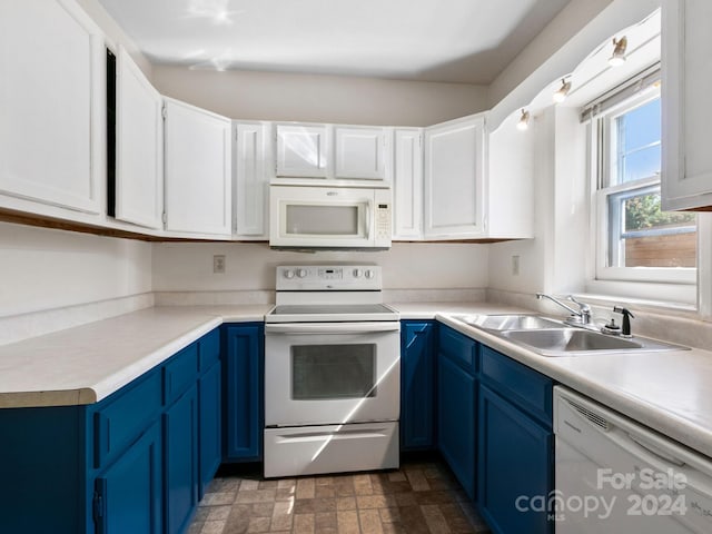 kitchen with blue cabinetry, white cabinets, and white appliances