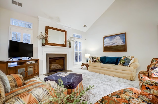 carpeted living room featuring high vaulted ceiling