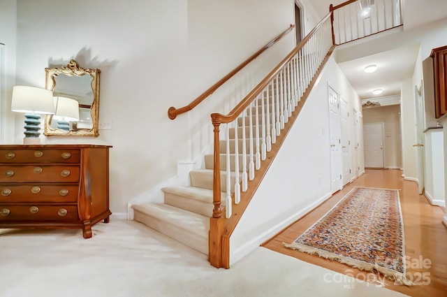 stairs featuring a towering ceiling