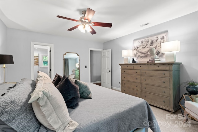 bedroom with ceiling fan and light colored carpet