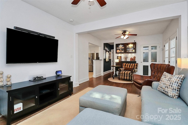 living room featuring a textured ceiling and hardwood / wood-style flooring