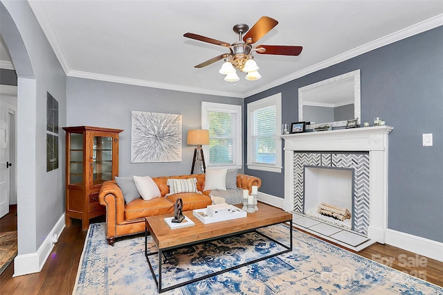 living room with dark hardwood / wood-style floors, ceiling fan, and crown molding