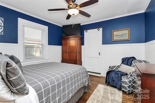 bedroom featuring dark hardwood / wood-style flooring, ceiling fan, and ornamental molding