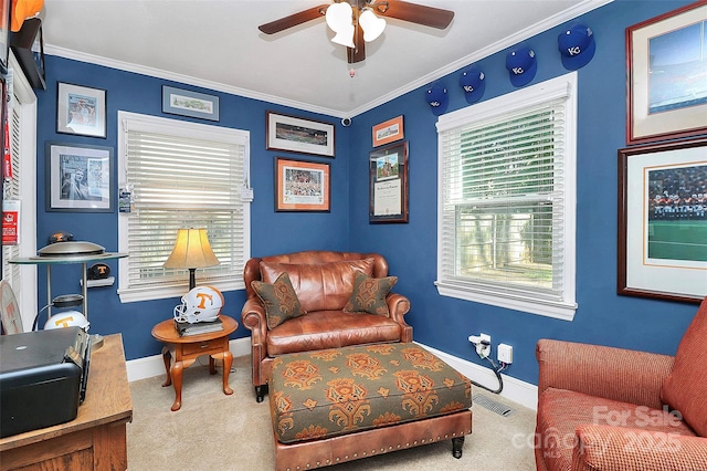 sitting room featuring ceiling fan, carpet floors, and ornamental molding