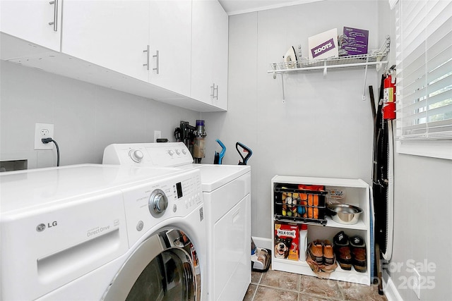 laundry area featuring cabinets and washing machine and dryer