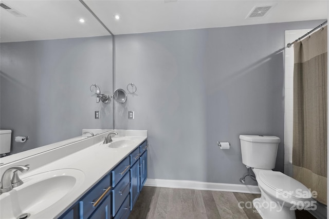 bathroom featuring toilet, vanity, hardwood / wood-style flooring, and a shower with curtain