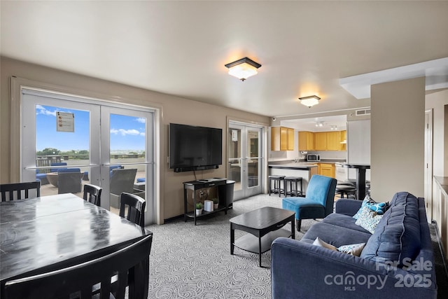 carpeted living room featuring french doors