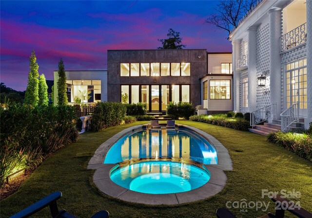 pool at dusk with a yard