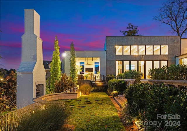 back house at dusk with a yard