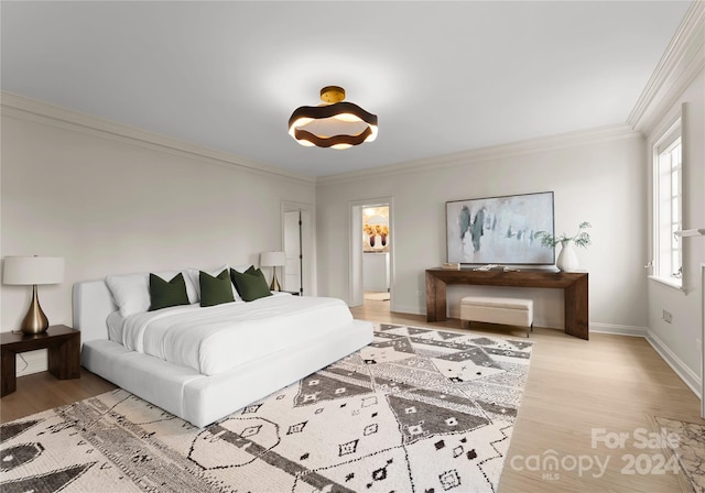 bedroom with light wood-type flooring and ornamental molding