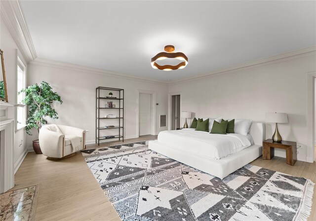 bedroom featuring crown molding and light hardwood / wood-style floors