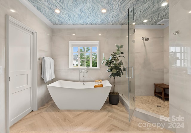 bathroom with shower with separate bathtub and parquet flooring