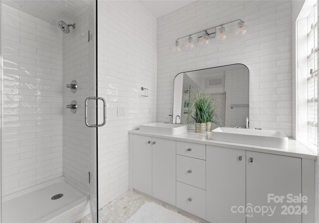 bathroom with vanity and a shower with shower door