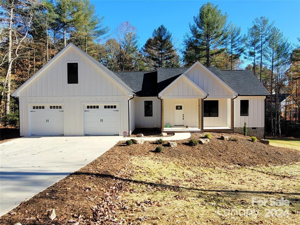 modern farmhouse style home with a garage and a porch