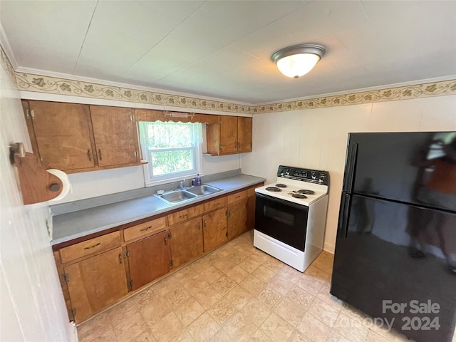 kitchen featuring crown molding, sink, black fridge, and white range with electric stovetop