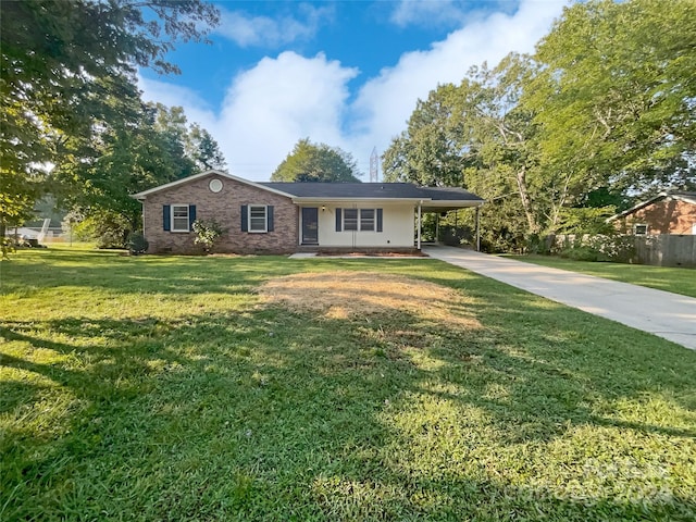 ranch-style home featuring a carport and a front lawn