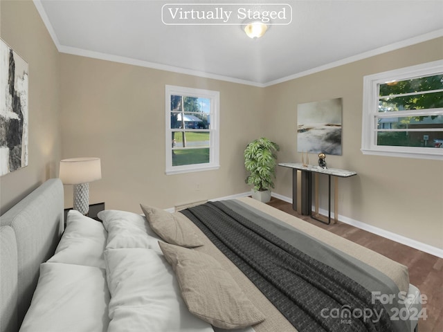 bedroom with ornamental molding, multiple windows, and dark hardwood / wood-style floors