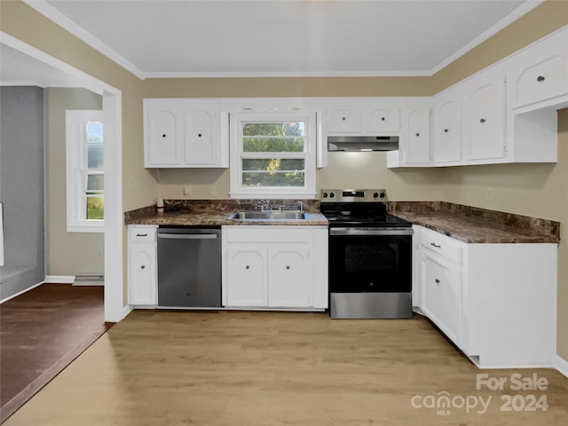 kitchen featuring light wood-type flooring, white cabinets, and stainless steel appliances