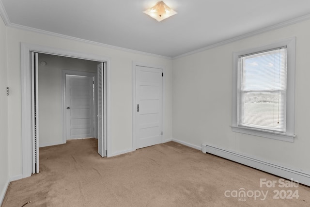 unfurnished bedroom featuring a baseboard heating unit, ornamental molding, and light colored carpet