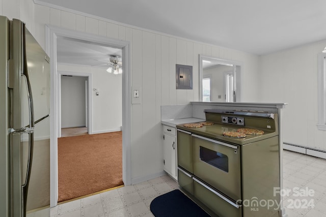 kitchen featuring baseboard heating, stainless steel appliances, electric panel, ceiling fan, and green cabinetry