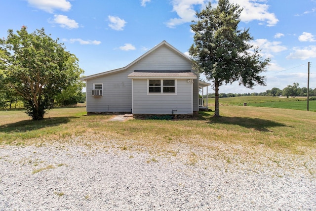 exterior space with cooling unit and a lawn