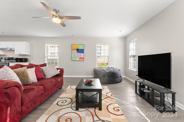 living room with ceiling fan and light hardwood / wood-style floors