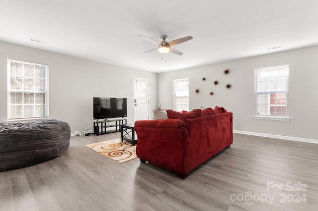 living room with ceiling fan and hardwood / wood-style flooring