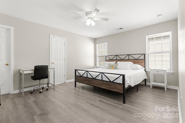 bedroom with ceiling fan and light wood-type flooring