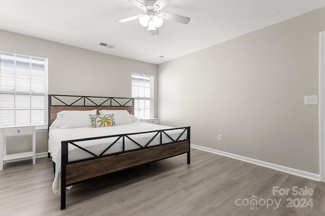 bedroom with ceiling fan and light hardwood / wood-style flooring