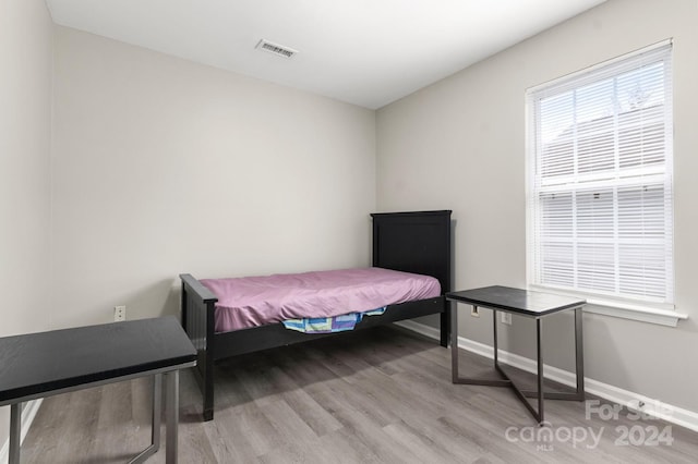 bedroom with hardwood / wood-style floors