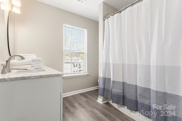 bathroom featuring a shower with shower curtain, vanity, plenty of natural light, and wood-type flooring