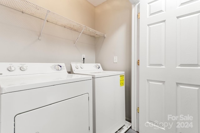 clothes washing area with washer and dryer