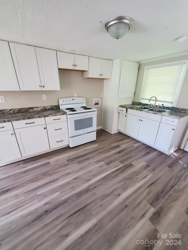 kitchen with white cabinets, white range with electric cooktop, and light hardwood / wood-style floors