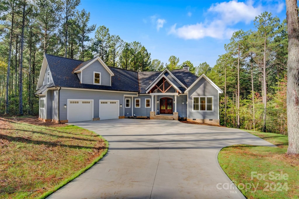 view of front of house with a garage and a front lawn