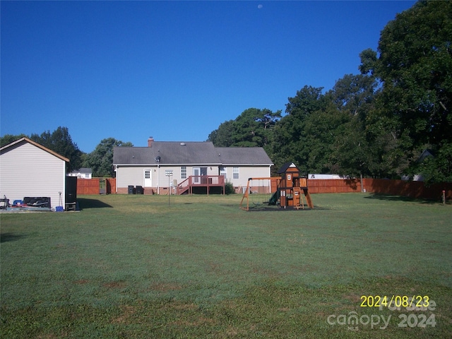 view of yard with a playground and a wooden deck