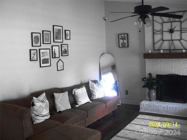 living room with a fireplace, ceiling fan, and dark hardwood / wood-style flooring