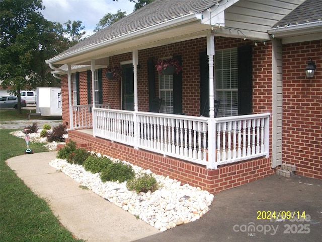 view of property exterior featuring covered porch