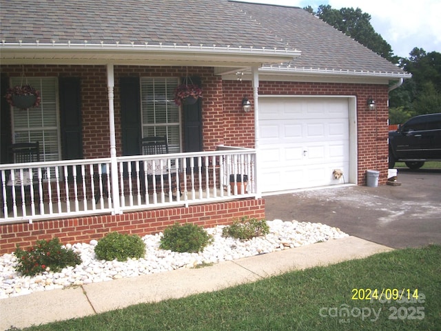 view of front of house with a garage and covered porch