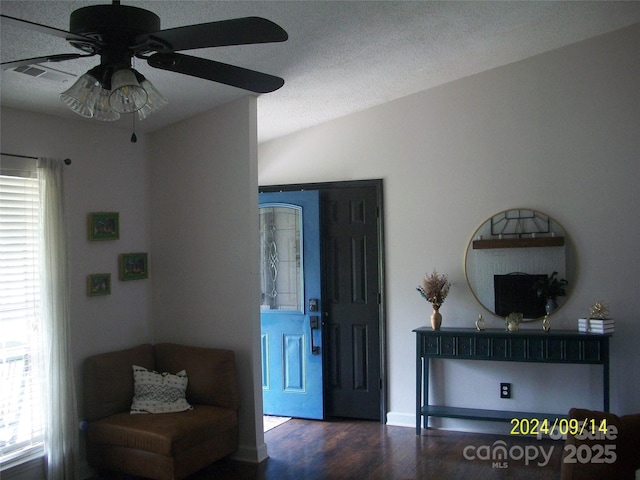 living area with lofted ceiling, dark hardwood / wood-style floors, and ceiling fan