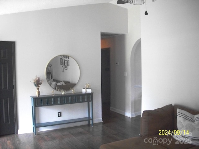 corridor with vaulted ceiling and dark hardwood / wood-style flooring