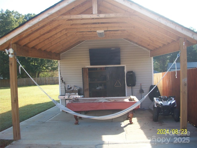 exterior space featuring a carport and a lawn