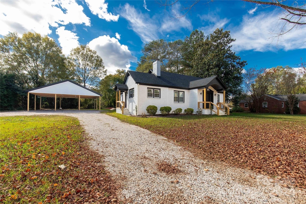 view of front of home with a carport and a front yard