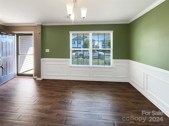 unfurnished dining area with a chandelier, a wainscoted wall, ornamental molding, and dark wood-style floors