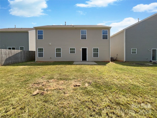 back of house featuring central AC unit, a patio area, fence, and a yard