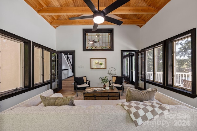 bedroom featuring wood-type flooring, beam ceiling, ceiling fan, and wooden ceiling